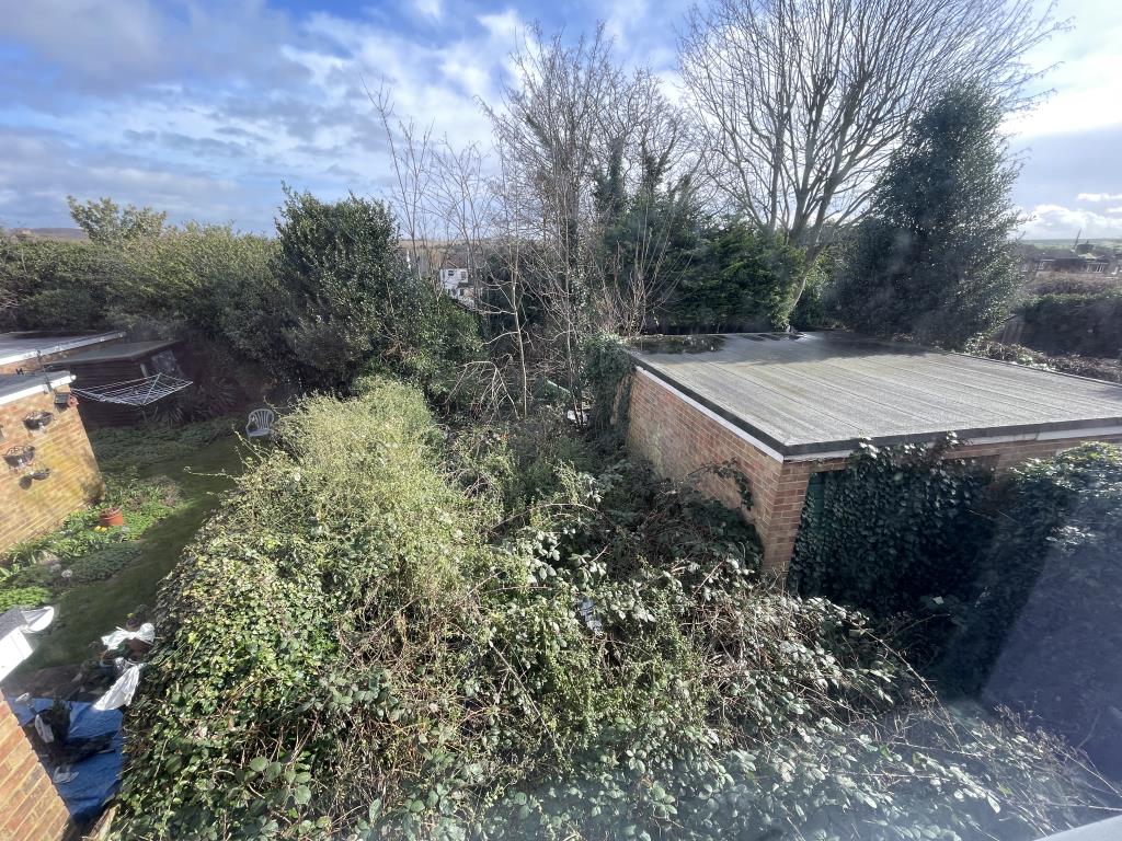 Lot: 78 - SEMI-DETACHED HOUSE IN POPULAR VILLAGE - Inside image taken from second bedroom overlooking rear garden and garage